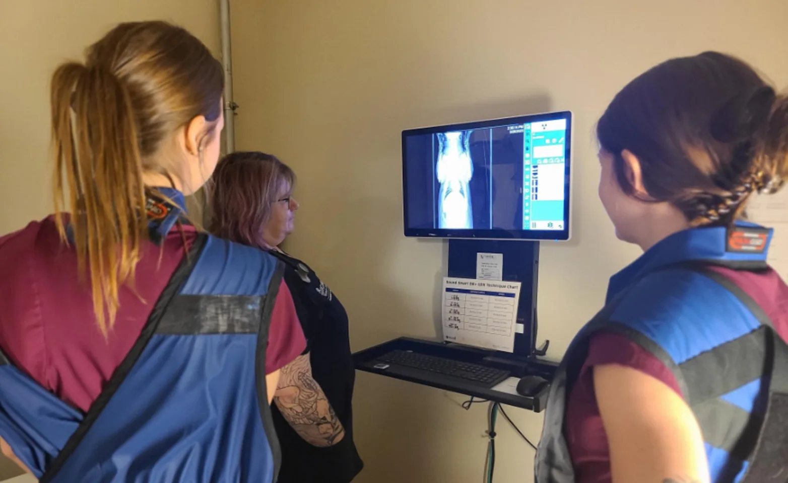 Three female staff members reviewing a diagnostic image